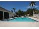 View of the community pool with lounge chairs and umbrellas, perfect for relaxation and recreation at 10662 Woodchase Cir, Orlando, FL 32836