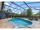 A sparkling screened-in pool with brick pavers offers a relaxing outdoor space at 10662 Woodchase Cir, Orlando, FL 32836