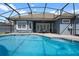 Back of the house with a screened-in pool featuring patio furniture at 10662 Woodchase Cir, Orlando, FL 32836