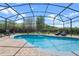 Inviting screened-in pool area with brick pavers and comfortable lounge chairs at 10662 Woodchase Cir, Orlando, FL 32836