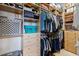 A walk-in closet features custom shelving and ample space for storage at 10662 Woodchase Cir, Orlando, FL 32836