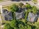 Aerial view of neighborhood homes featuring screened-in pools, mature trees, and manicured lawns at 1125 E Tuskawilla Pt, Winter Springs, FL 32708