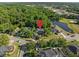 Aerial view of a luxury home nestled among trees and with lake view at 1125 E Tuskawilla Pt, Winter Springs, FL 32708