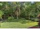 Serene backyard with mature trees and lush greenery providing privacy at 1125 E Tuskawilla Pt, Winter Springs, FL 32708