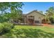 Spacious backyard featuring a screened-in patio and a well-maintained lawn at 1125 E Tuskawilla Pt, Winter Springs, FL 32708