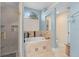 Modern bathroom featuring a glass enclosed shower and soaking tub with tile surround at 1125 E Tuskawilla Pt, Winter Springs, FL 32708