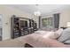 Main bedroom featuring a large entertainment center and views of the screened-in porch at 1125 E Tuskawilla Pt, Winter Springs, FL 32708