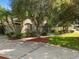 Beautiful home exterior with mature trees, green lawn, and inviting curb appeal at 1125 E Tuskawilla Pt, Winter Springs, FL 32708
