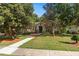Charming single-story home with mature trees and manicured landscaping at 1125 E Tuskawilla Pt, Winter Springs, FL 32708