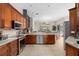 Well-lit kitchen with stainless steel appliances and a view into the living room area at 1125 E Tuskawilla Pt, Winter Springs, FL 32708