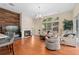 Inviting living room featuring a stone fireplace and large windows for natural light at 1125 E Tuskawilla Pt, Winter Springs, FL 32708