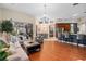 Open-concept living area with a stylish bar, seamlessly connecting to the dining area and outdoor patio at 1125 E Tuskawilla Pt, Winter Springs, FL 32708