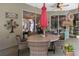 Cozy patio area with a round table, umbrella, and wicker chairs for outdoor dining at 1125 E Tuskawilla Pt, Winter Springs, FL 32708