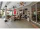 Inviting covered patio with ceiling fans, outdoor dining, and comfortable seating, creating an ideal outdoor retreat at 1125 E Tuskawilla Pt, Winter Springs, FL 32708