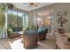 Relaxing screened-in patio featuring comfortable seating and view of the manicured backyard at 1125 E Tuskawilla Pt, Winter Springs, FL 32708