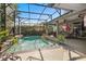 Inviting screened pool with a waterfall, plants, and outdoor dining, perfect for entertaining at 1125 E Tuskawilla Pt, Winter Springs, FL 32708