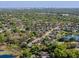 Wide aerial of the neighborhood featuring mature trees, lush lawns and established houses near a water tower at 1137 Palm Cove Dr, Orlando, FL 32835