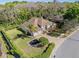 Aerial view of a single-Gathering home featuring a brick driveway, mature trees, and well-maintained landscaping at 1137 Palm Cove Dr, Orlando, FL 32835