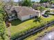 Aerial view of the backyard featuring an in-ground screened pool, fenced yard, and lake views at 1137 Palm Cove Dr, Orlando, FL 32835