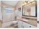 Bathroom with a shower/tub combo, granite vanity, and framed mirror at 1137 Palm Cove Dr, Orlando, FL 32835