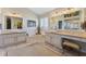 Bathroom featuring double vanities, a large mirror, and a corner tub with natural light at 1137 Palm Cove Dr, Orlando, FL 32835