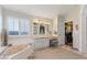 Bathroom featuring a double vanity, bath tub, and a walk-in closet at 1137 Palm Cove Dr, Orlando, FL 32835