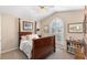 This bedroom features a four-poster bed, shuttered windows, and ample natural light at 1137 Palm Cove Dr, Orlando, FL 32835