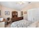 Cozy bedroom with neutral walls, a queen bed with blue floral bedding, and an antique dresser at 1137 Palm Cove Dr, Orlando, FL 32835