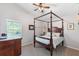 Bedroom with a four-poster bed, ceiling fan, and natural light from the window at 1137 Palm Cove Dr, Orlando, FL 32835