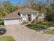 Well maintained single-Gathering home with a lush landscaped yard and a brick paved driveway leading to a two-car garage at 1137 Palm Cove Dr, Orlando, FL 32835