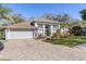 Charming single-Gathering home featuring a brick driveway, two-car garage, and well-manicured landscaping at 1137 Palm Cove Dr, Orlando, FL 32835