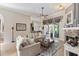 Bright and airy living room featuring neutral tones, a glass coffee table and access to the outdoor lanai at 1137 Palm Cove Dr, Orlando, FL 32835