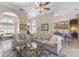 Open-concept living room featuring neutral tones, arched doorways and easy access to the kitchen and dining areas at 1137 Palm Cove Dr, Orlando, FL 32835