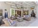 Covered patio featuring comfortable seating with striped cushions, a ceiling fan, and tile flooring at 1137 Palm Cove Dr, Orlando, FL 32835
