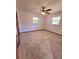 Bedroom features carpet, windows, a ceiling fan, and a closet with louvered doors at 1212 Foxfire Dr, Apopka, FL 32712
