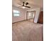 Bedroom with a ceiling fan, window, carpet floors, closet, and neutral colored walls at 1212 Foxfire Dr, Apopka, FL 32712