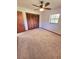 This bedroom features carpet floors, a ceiling fan, closet, and natural light from a window at 1212 Foxfire Dr, Apopka, FL 32712