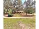 A charming home with mature trees and lush green lawn creating an inviting curb appeal at 1212 Foxfire Dr, Apopka, FL 32712