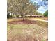 A charming home with mature trees and a well manicured lawn creating an inviting curb appeal at 1212 Foxfire Dr, Apopka, FL 32712