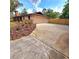 Exterior view of two car garage with extra long driveway, and partial fenced back yard at 1212 Foxfire Dr, Apopka, FL 32712