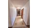 View of the long hallway leading to other rooms within the home featuring tiled floors at 1212 Foxfire Dr, Apopka, FL 32712