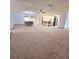 Expansive living room featuring an open floor plan with dining area, breakfast bar, and a neutral color palette at 1212 Foxfire Dr, Apopka, FL 32712
