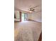Spacious living room with carpet, ceiling fan, sliding glass doors to the backyard at 1212 Foxfire Dr, Apopka, FL 32712