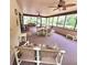 Relaxing screened patio featuring ceiling fans, comfortable seating, and views of the backyard at 1212 Foxfire Dr, Apopka, FL 32712