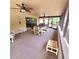 Relaxing screened patio featuring ceiling fans, comfortable seating, and views of the backyard at 1212 Foxfire Dr, Apopka, FL 32712
