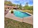Backyard oasis with in-ground pool, beautiful landscaping, and a screened-in patio at 1212 Foxfire Dr, Apopka, FL 32712