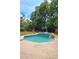 Backyard featuring a sparkling in-ground pool surrounded by lush landscaping at 1212 Foxfire Dr, Apopka, FL 32712