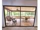 Relaxing screened porch with swing and seating, offering a serene outdoor retreat, and a view of the backyard at 1212 Foxfire Dr, Apopka, FL 32712