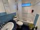 Bathroom with shower-tub combo, single sink vanity and blue tile accent at 1221 Perkins Rd, Orlando, FL 32809