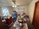 View of bedroom with disorganized items, with a ceiling fan and blue curtains at 1221 Perkins Rd, Orlando, FL 32809